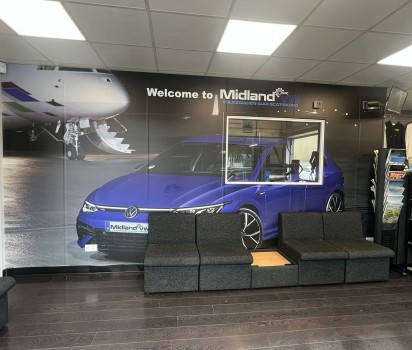 Midland VW waiting room with a poster of a blue car and MOT viewing window